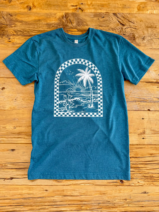 Oceanside Unisex tee with a white checkered arch design with a coastal scene inside the arch. 