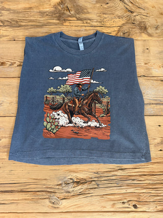 Faded Navy muscle tank with a graphic of a cowboy riding a horse with an American Flag. 