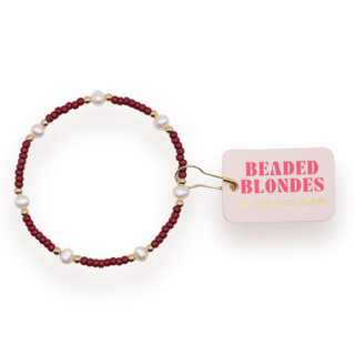 maroon, pearl, and gold beaded bracelet. 