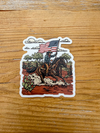 Sticker of a cowboy riding a horse with an American flag.