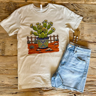 off white unisex tee with potted cactus scene. 