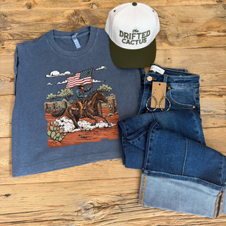 Faded Navy muscle tank with a graphic of a cowboy riding a horse with an American Flag. 