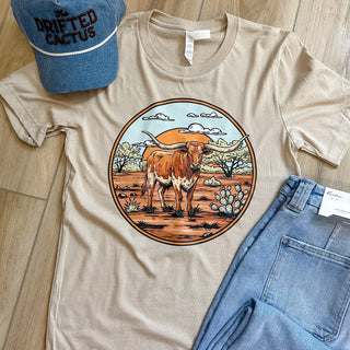 tan -tshirt with a longhorn standing on south texas landscape 