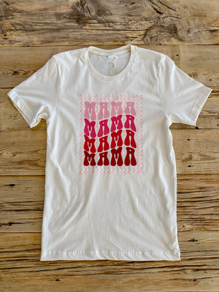 White tee with a pink retro Mama text with checkered background. 