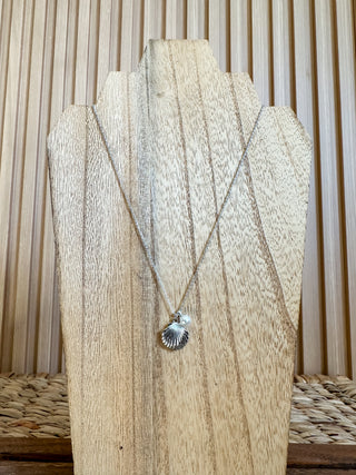 silver necklace with a clam shell and pearl charms. 