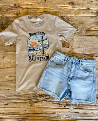 tan t-shirt with a coastal scene and cross with stay salty, you are the salt of the earth matthew 5:13