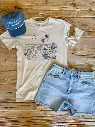 Washed Natural colored tee with cactus and palm on the beach scene. 