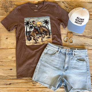 Brown t-shirt with a coastal cowboy design( cowboy riding a horse on the beach).