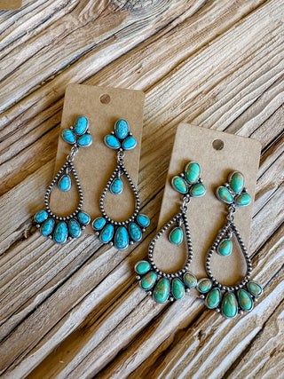 two pairs of turquoise dangle post back earrings. one blue turquoise color and one green turquoise color. 