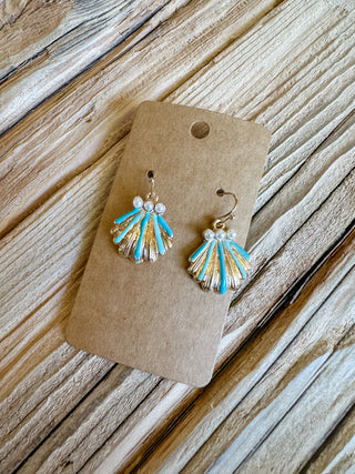 clam shell dangle earrings with turquoise/blue/gold coloring and pearl accents. 