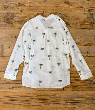 Back of white long sleeve button up with palm tree embroidered pattern. 