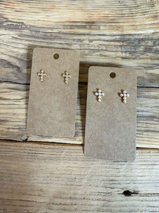 cross studs, one pair has faux pearls and one pair has faux diamonds. 
