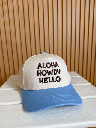 blue/khaki hat with brown puff embroidery that says aloha howdy hello. 