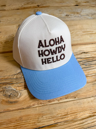 blue/khaki hat with brown puff embroidery that says aloha howdy hello. 