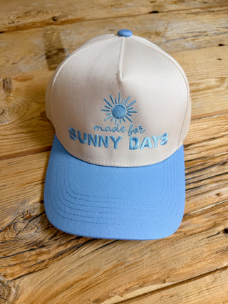 khaki and blue cap with 'made for SUNNY DAYS' embroidered text. 