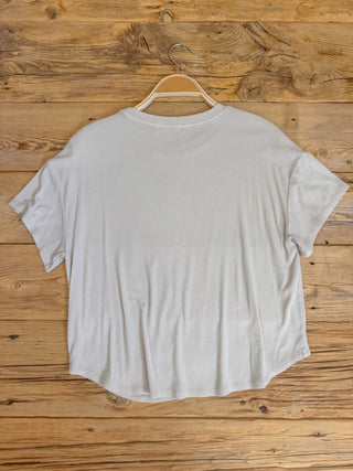 back of natural colored ribbed short sleeve top. 