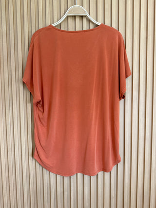 Back of rust short sleeve pocket tee. 
