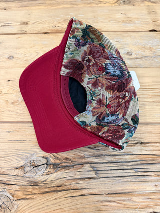 Back of the floral trucker hat showing snapback closure. 