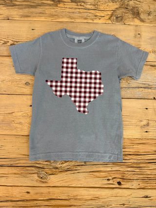 Dark grey short sleeve youth t-shirt with a maroon and white gingham texas graphic .