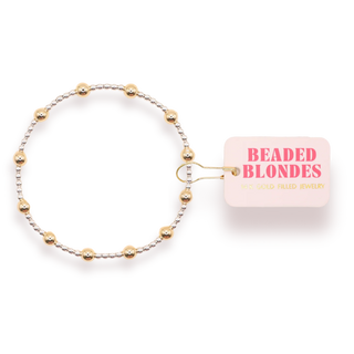 gold and silver beaded bracelet. 