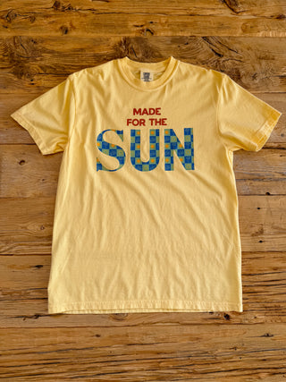 Banana colored tee with made for the sun graphic. Sun text has a checkered sun print. 