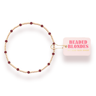 gold and maroon beaded bracelet. 