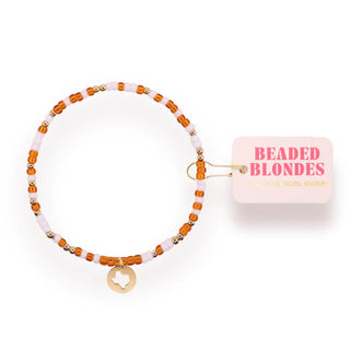 burnt orange, gold, and white beaded bracelet with a texas cutout dangle charm. 