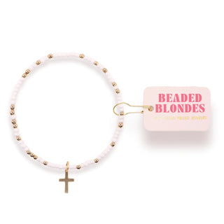 White and gold beaded bracelet with cross dangle charm. 