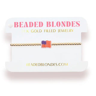 Gold beaded bracelet with an American Flag charm that does not dangle. 